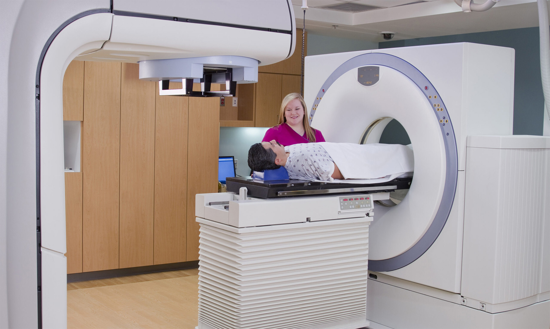 An MRI room with an attendant and a patient.
