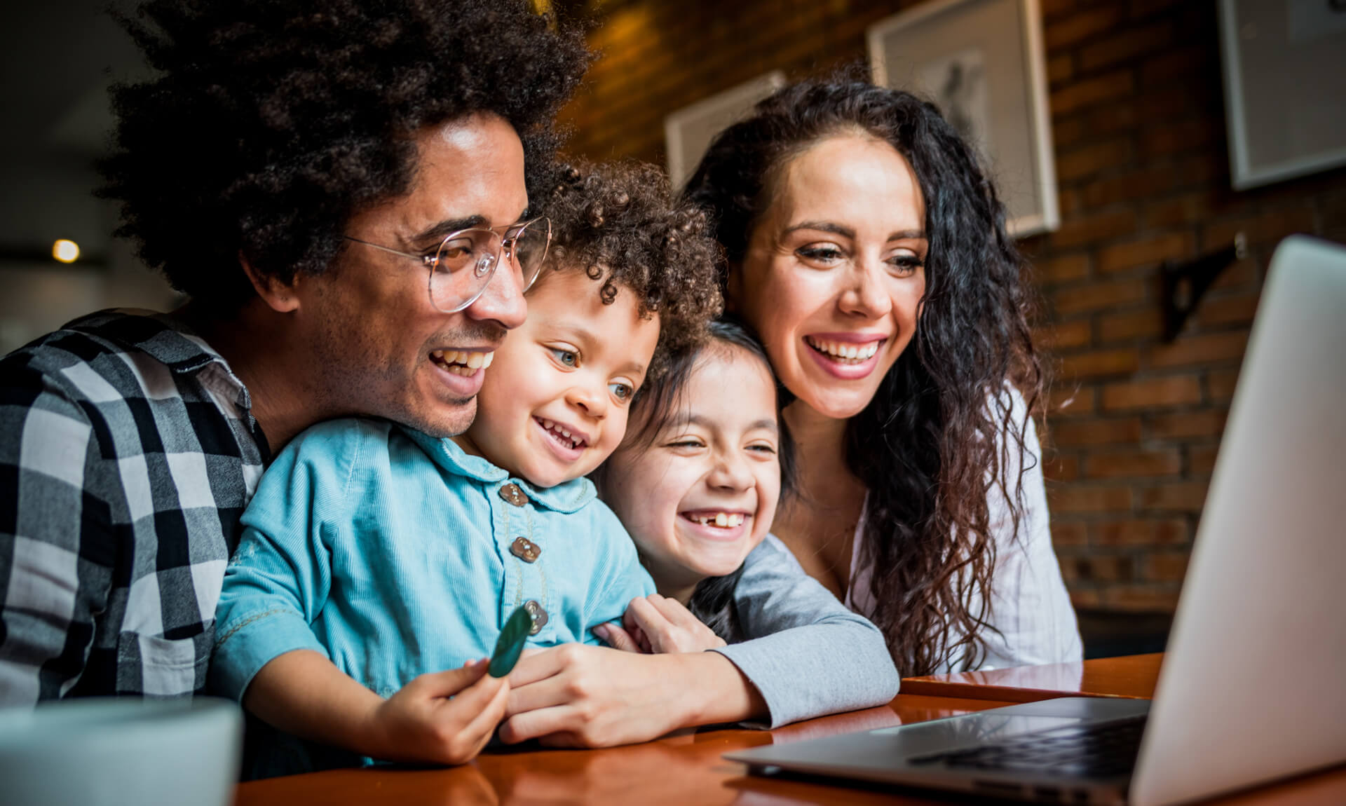 Parents Happy family having fun while using laptop together.