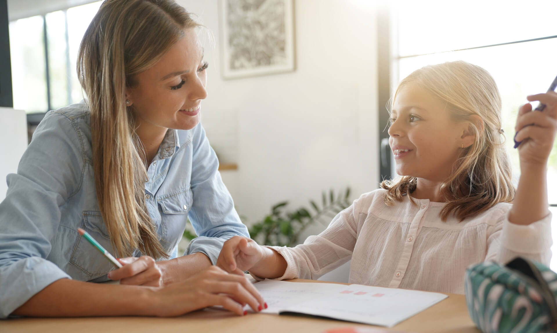 Understanding Dyslexia Mother helping daughter with homework.