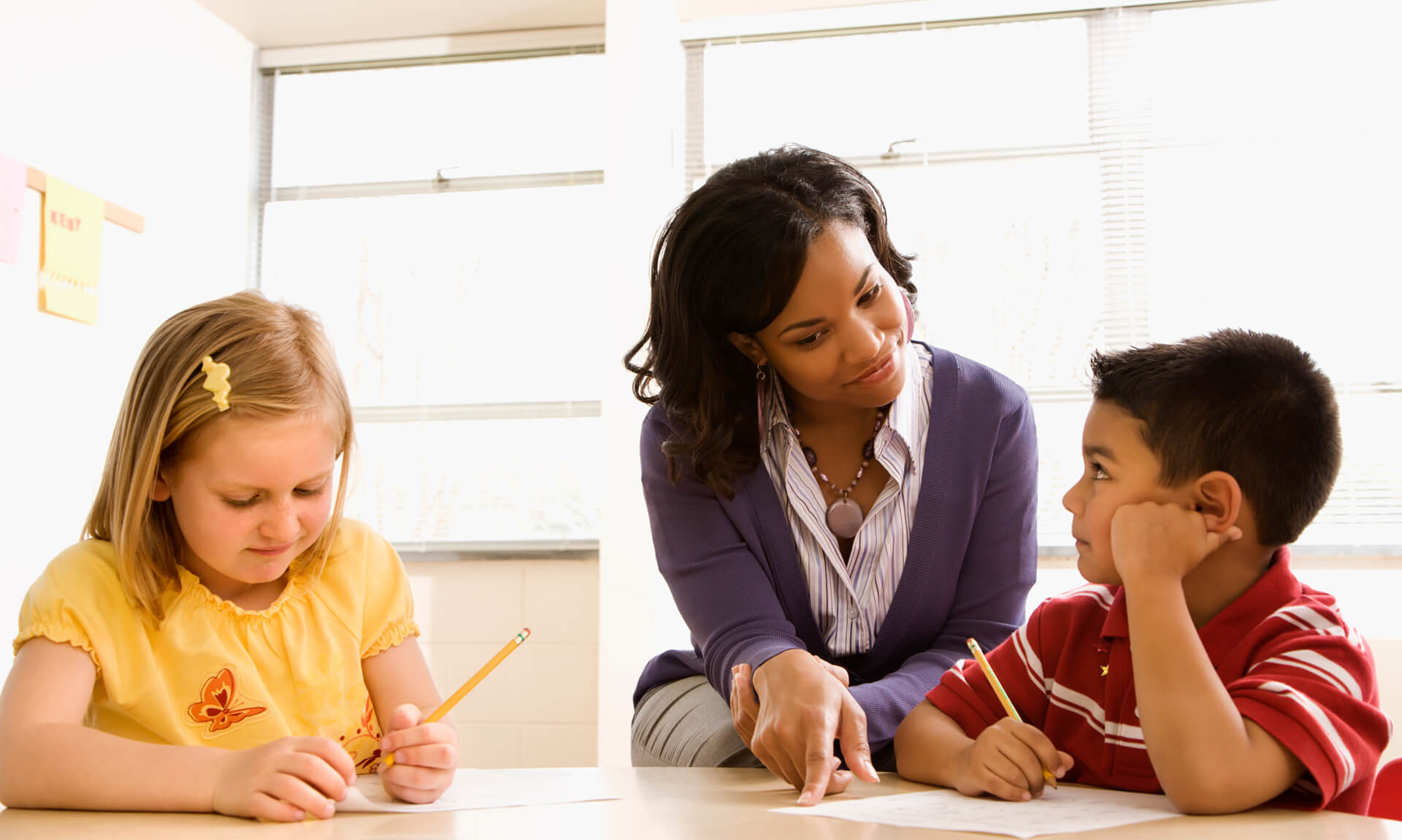 Teacher Helping Students With Schoolwork